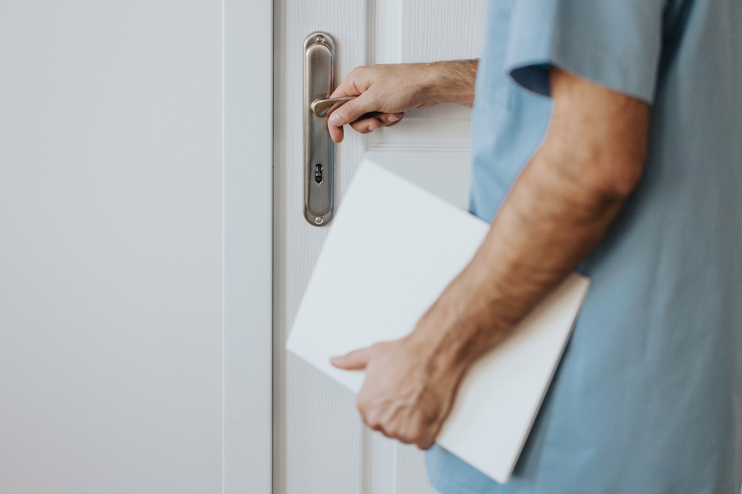 Close-up of young doctor holding medical history walking into the room